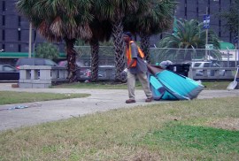 City contracted waste removal employees dragged any remaining tents and belongings into trash compactors, clearing the plaza, which earlier had been filled with hundreds of homeless.
