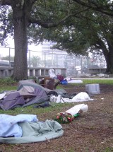 City contracted waste removal employees dragged any remaining tents and belongings into trash compactors, clearing the plaza, which earlier had been filled with hundreds of homeless.